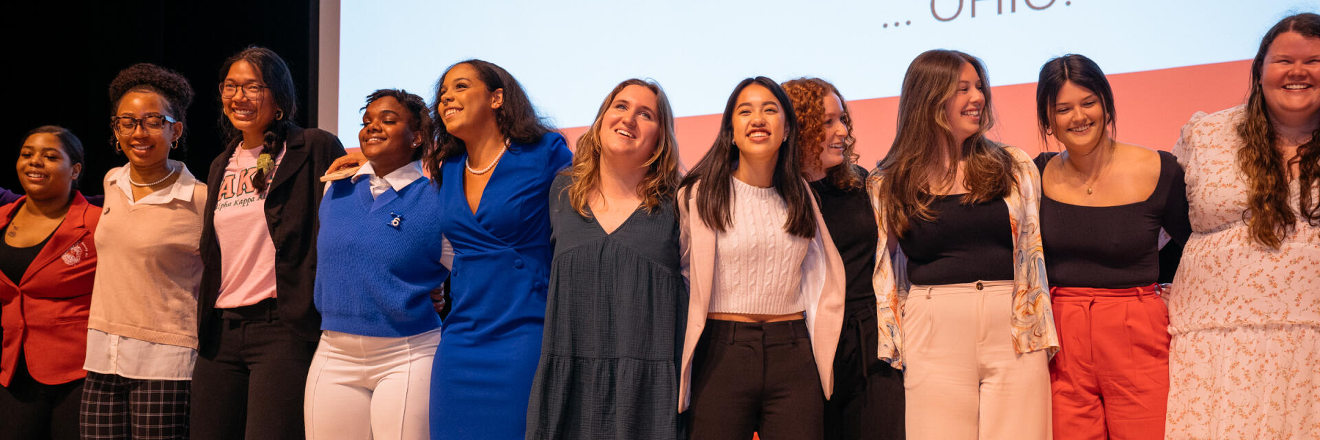 students on stage, arm in arm, singing Carmen Ohio at the 2023 SFL Awards